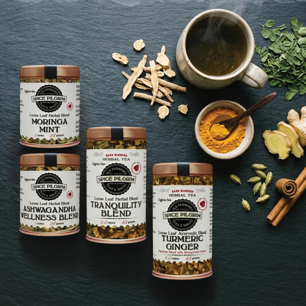Spice Pilgrim tea blends with ingredients on a dark surface