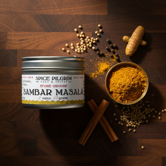 Spice Pilgrim Sambhar Masala container with ingredients on a wooden surface