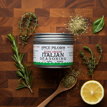 Spice Pilgrim Italian seasoning can on a wooden surface with herbs and lemon
