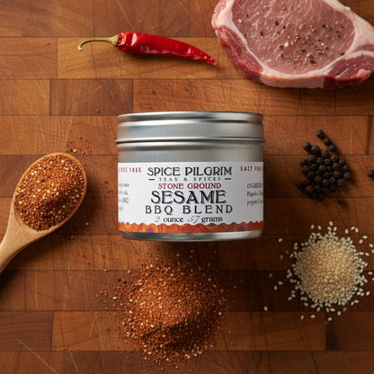 Spice Pilgrim Sesame BBQ Blend on a wooden surface with ingredients and a spoon.