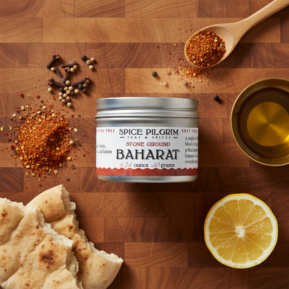 Spice Pilgrim Baharat container on a wooden surface with spices and lemon