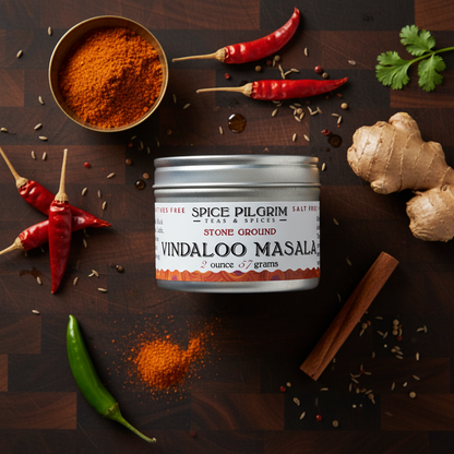 Spice Pilgrim Vindaloo Masala can with spices on a wooden surface