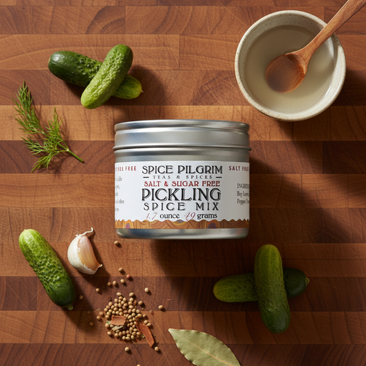 Spice Pilgrim pickling spice mix can on a wooden surface with cucumbers and spices.