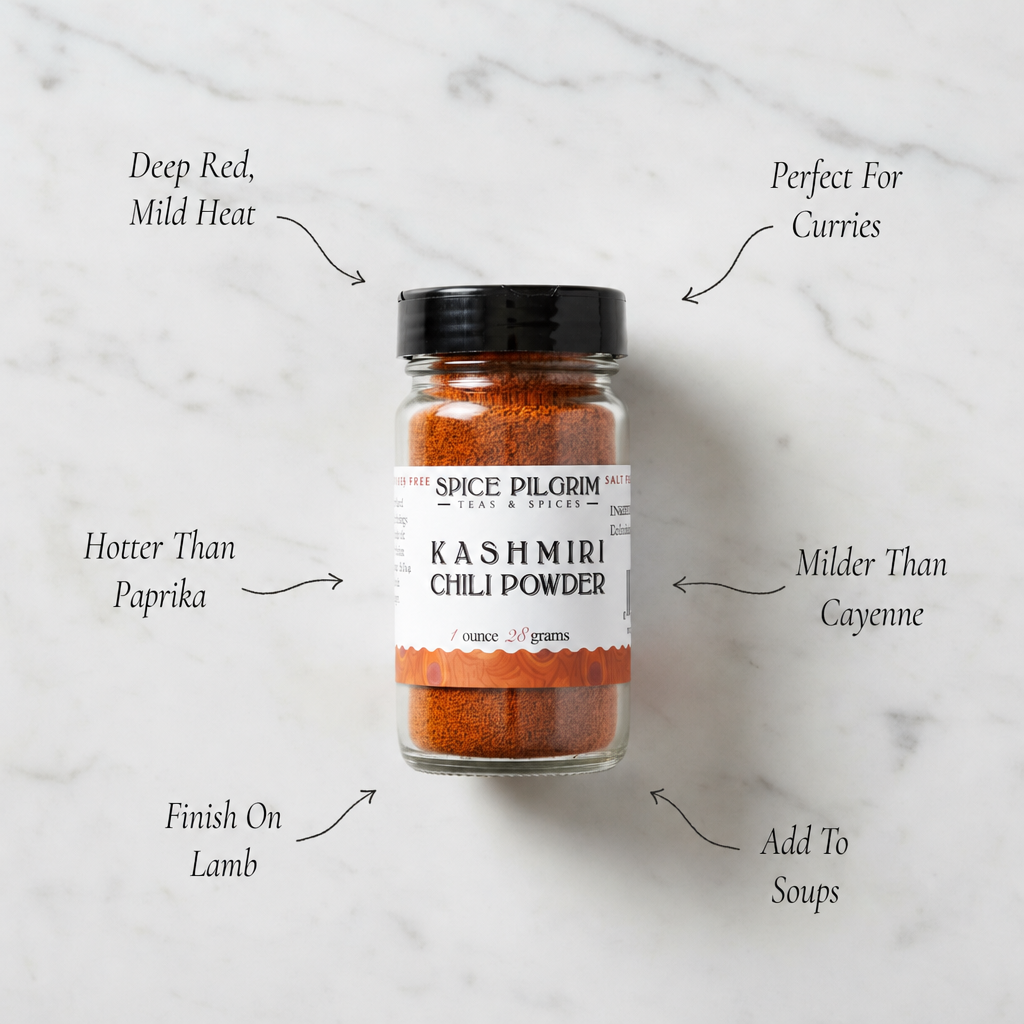 Jar of Spice Pilgrim Kashmiri chili powder on a marble background with text describing its properties.