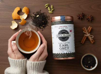 Product: Earl Grey. Inline image 5: Hands holding a warm mug of tea, view from above. Cozy sweater sleeves visible.