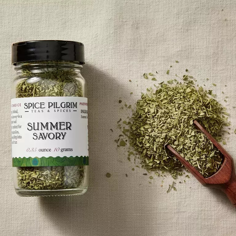 Spice Pilgrim Teas & Spices Summer Savory, 0.35 oz / 10g jar, shown with a wooden scoop and loose dried herb
